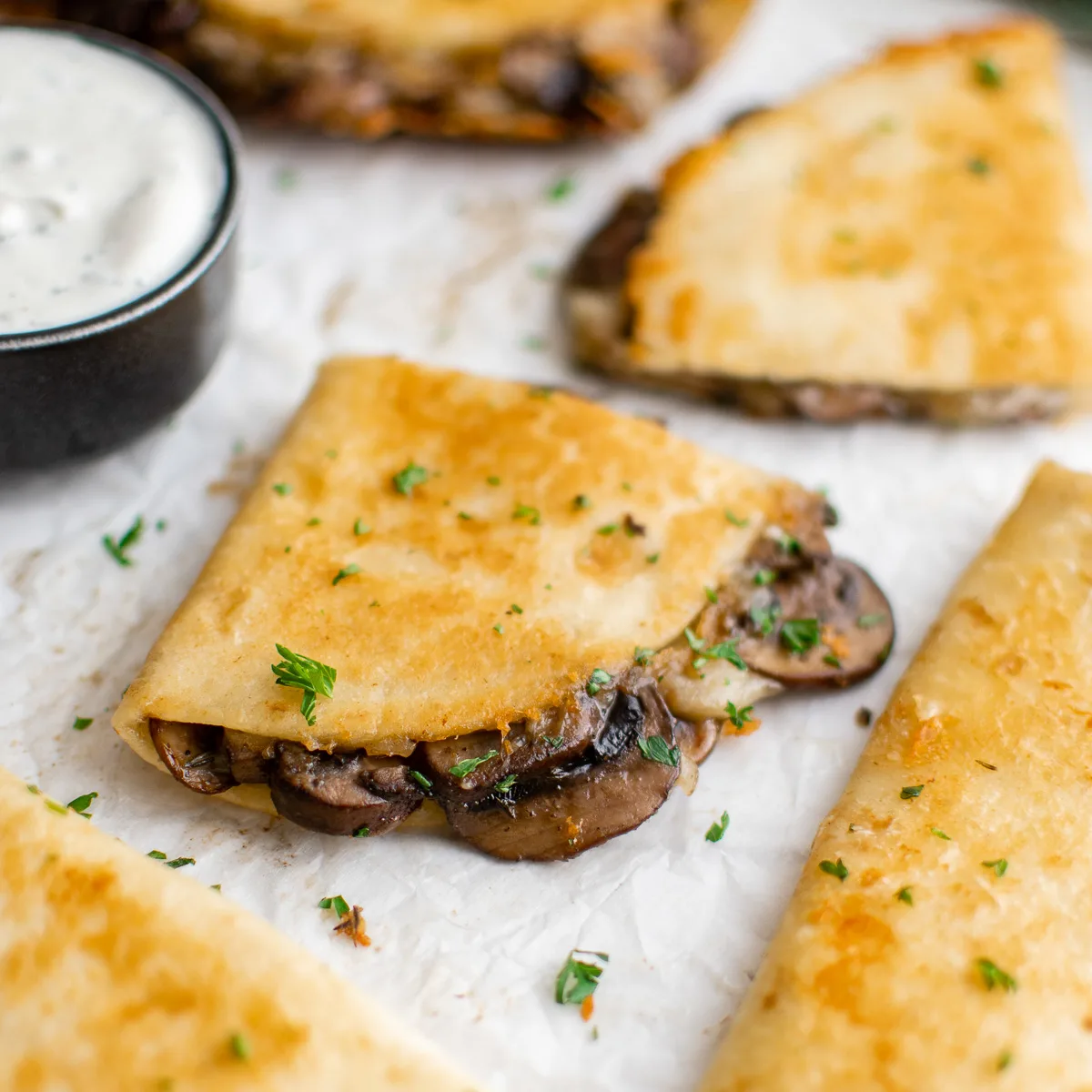 Quartered mushroom quesadillas with chives.