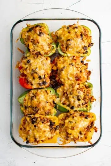 Top down view of stuffed bell peppers with melted cheese.