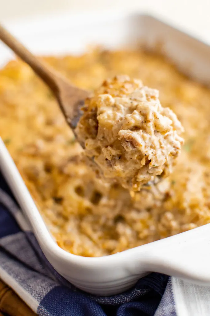 Biscuits and gravy casserole on a wooden spoon.