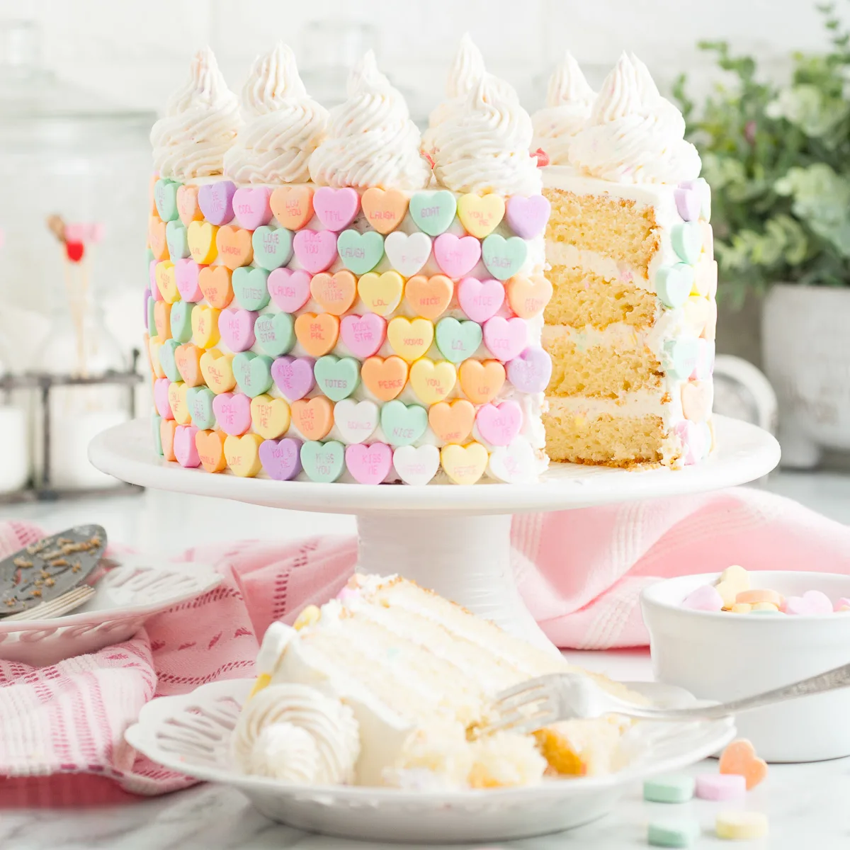 Slice of conversation heart cake on a plate.