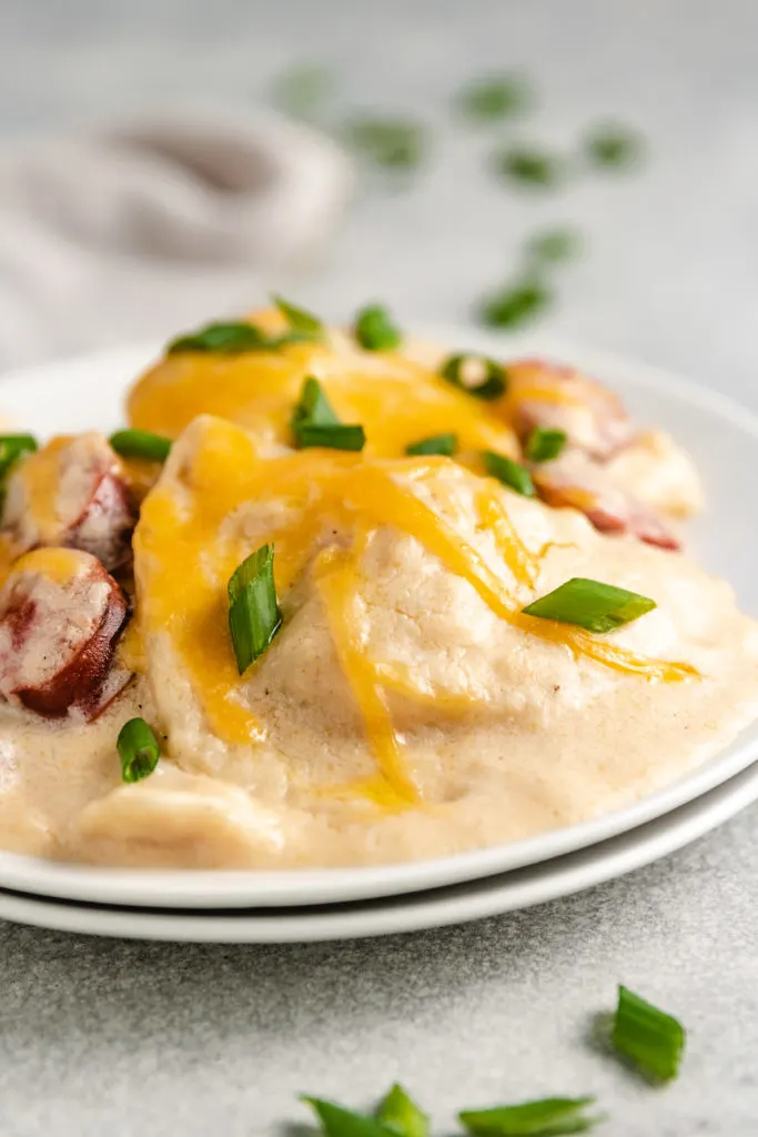 Close up view of crockpot pierogi and kielbasa casserole on a plate.