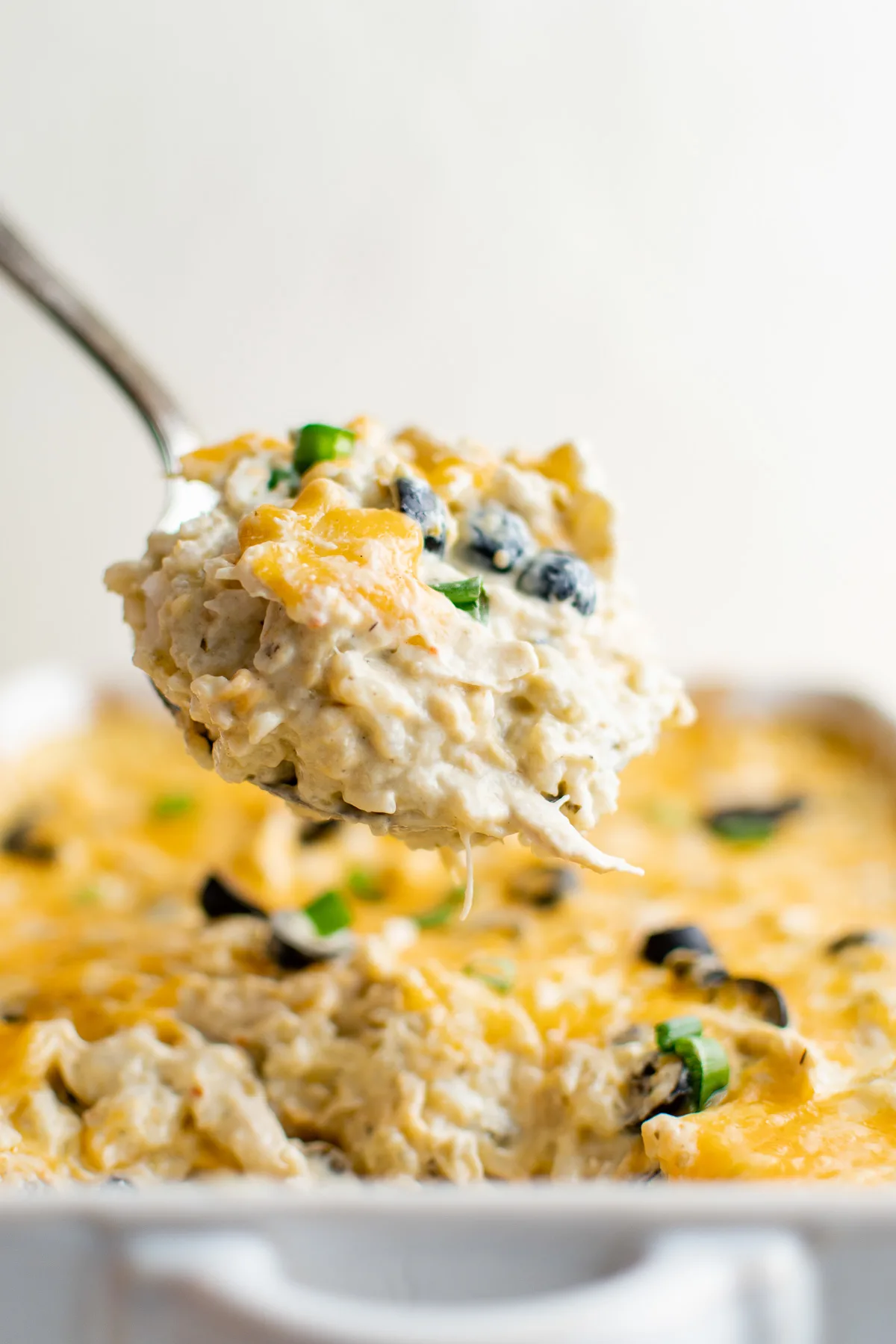 Scoop of green chile chicken casserole.