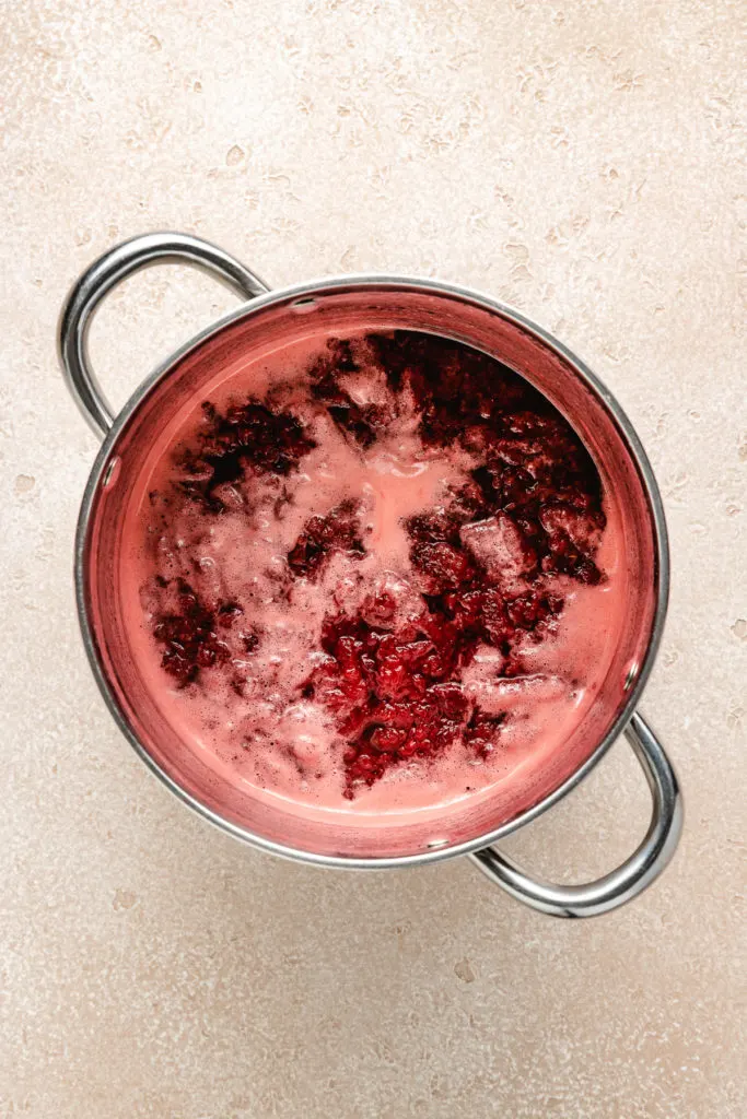 Cooked strawberries in a metal pan.