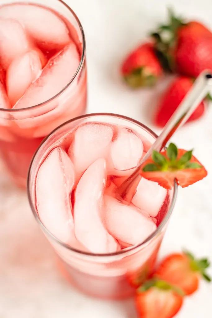 Top down view of a glass of strawberry soda.