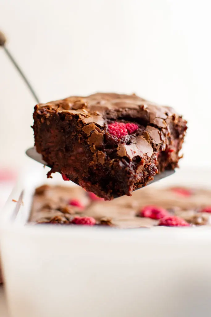 Raspberry brownie on a spatula.