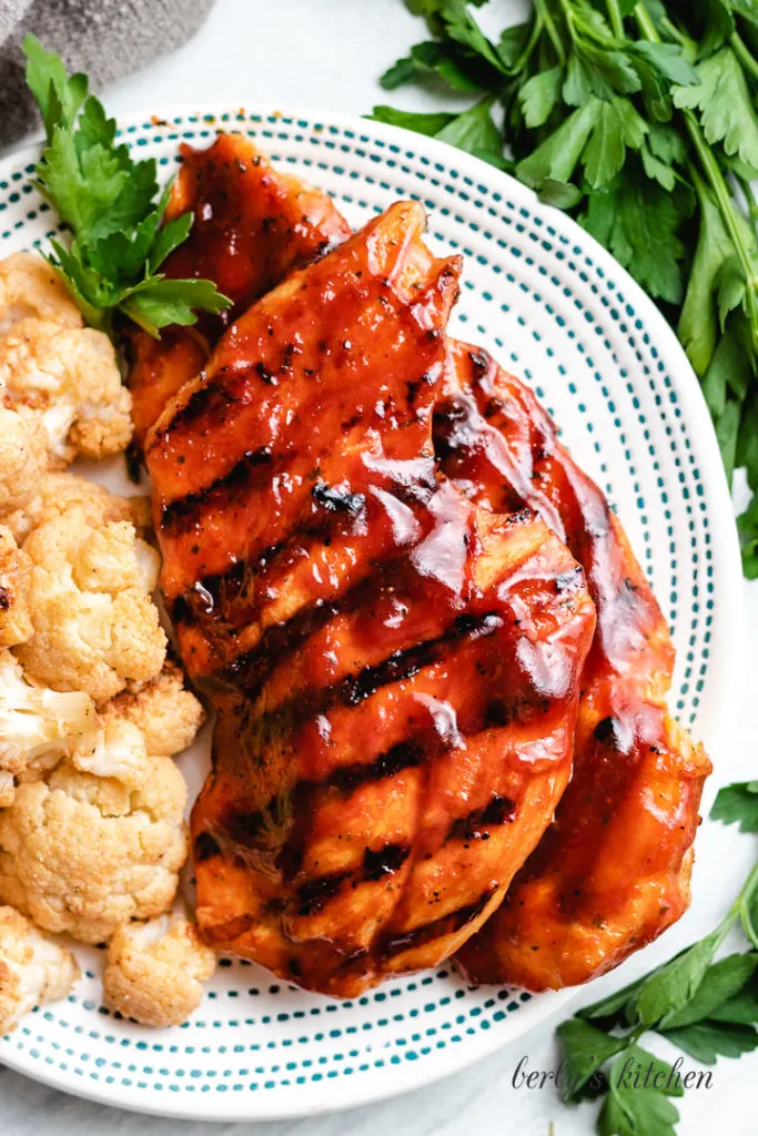 Top down view of two bbq chicken breasts.