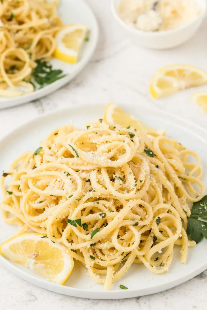 Close up view of lemon pasta with lemon slices.