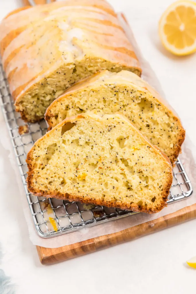 Sliced poppy seed bread on a cutting board.