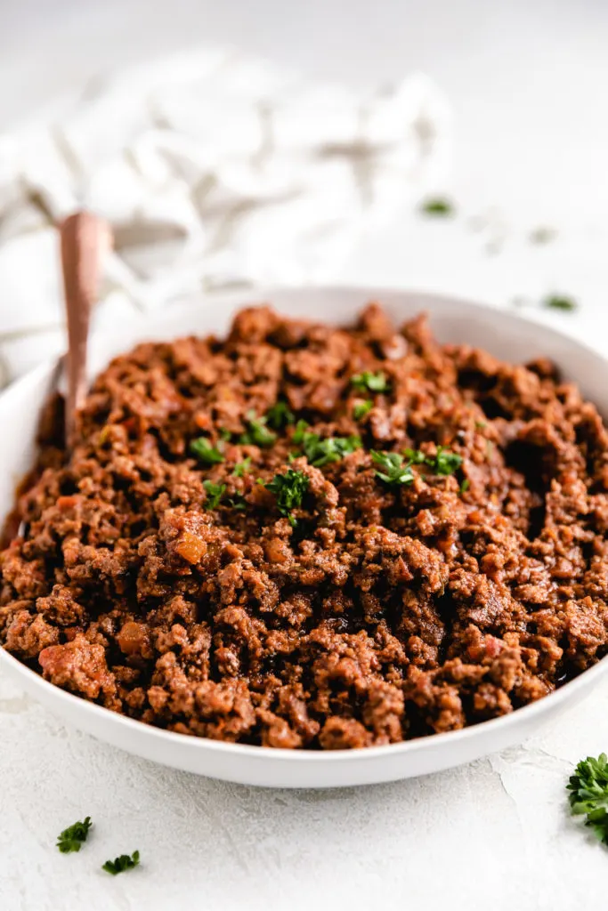 Close up view of crock pot taco meat in a gray dish.