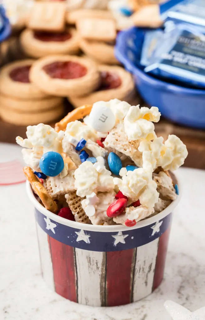 Festive bucket filled with 4th of july snack mix.