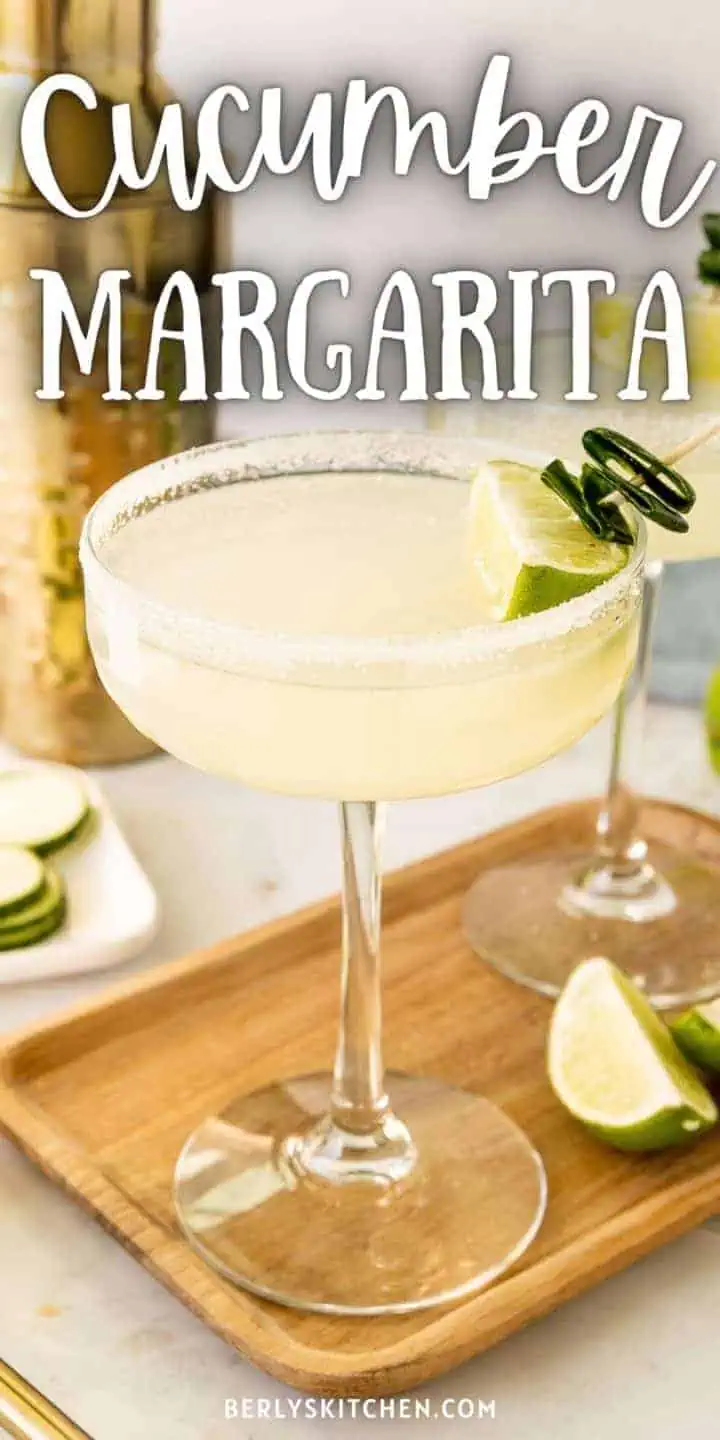 Two cucumber margaritas on a cutting board.