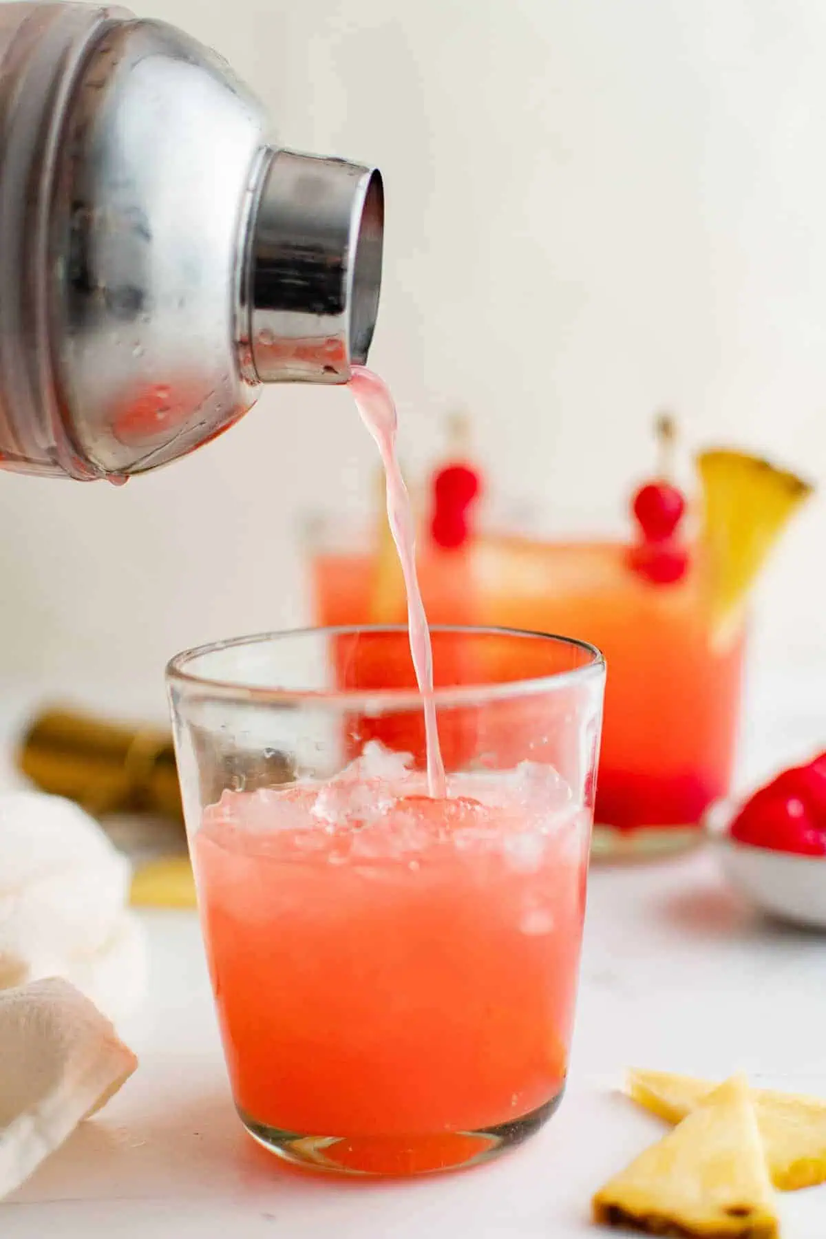 Cocktail being poured into a glass.