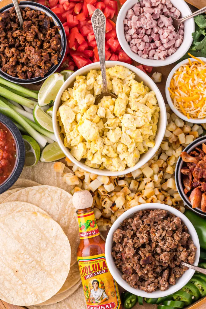 Close up view of bowls of food on a breakfast board.