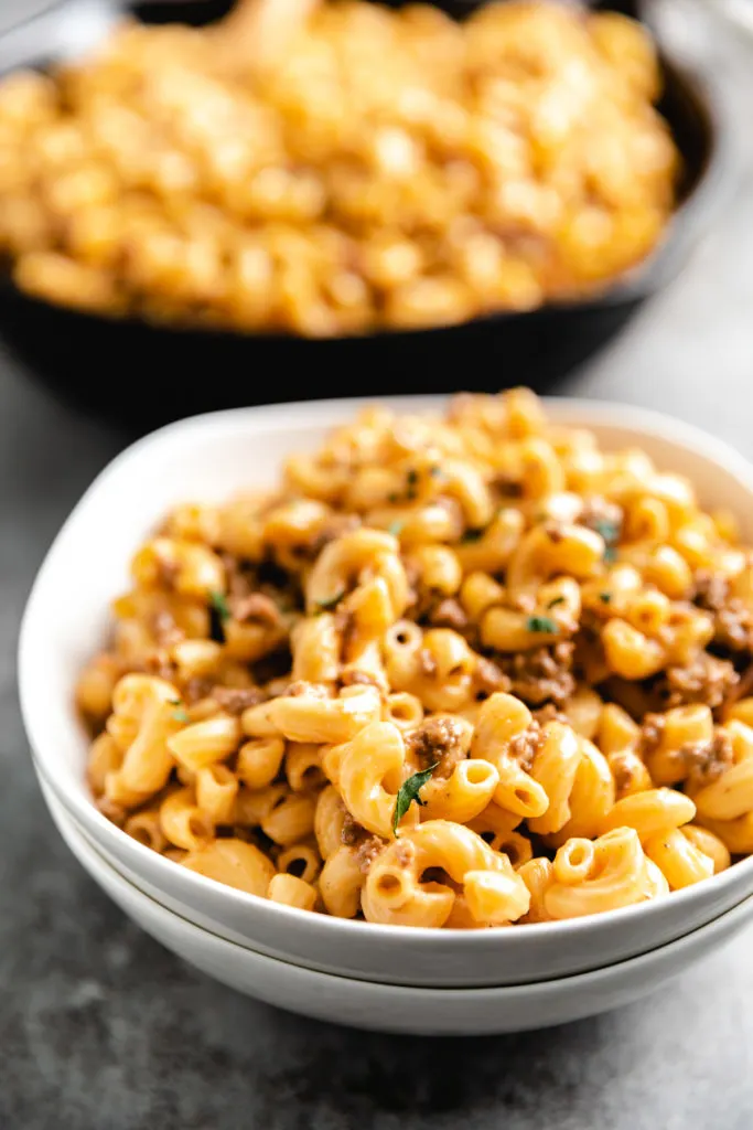 White bowls filled with hamburger helper.