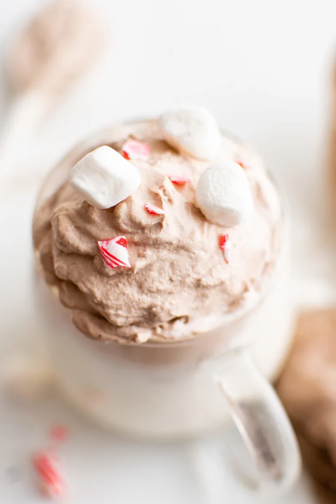 Top down view of a glass of warm hot cocoa.