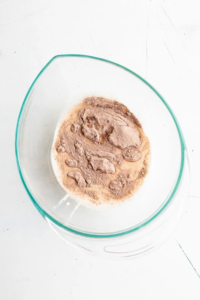 Heavy cream, hot chocolate mix and vanilla in a bowl.