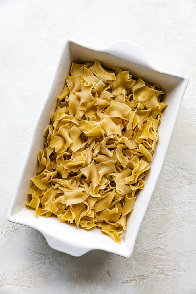 Egg noodles in a casserole dish.