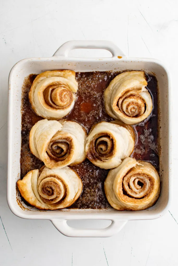 Baked cinnamon rolls in a dish.