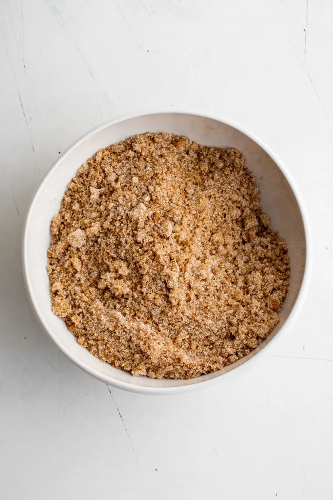 Cinnamon and sugar stirred in a bowl.