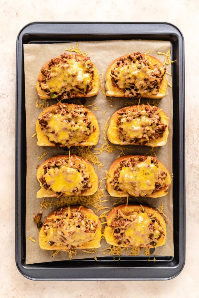 Top down view of melted cheese on top of texas toast sloppy joes.