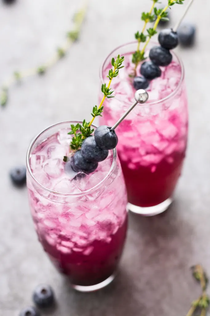 Angled view of a blueberry cocktail made with gin.