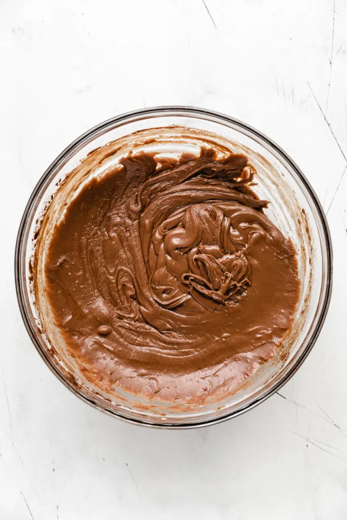 Chocolate fudge icing in a bowl.