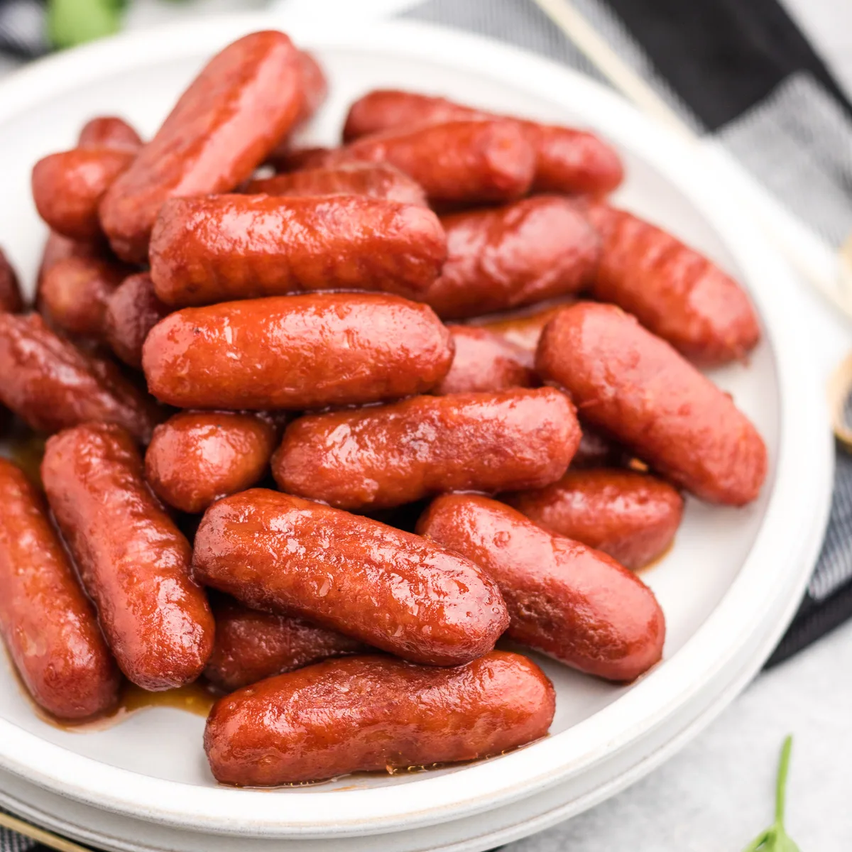 Close up view of crockpot little smokies on two plates.