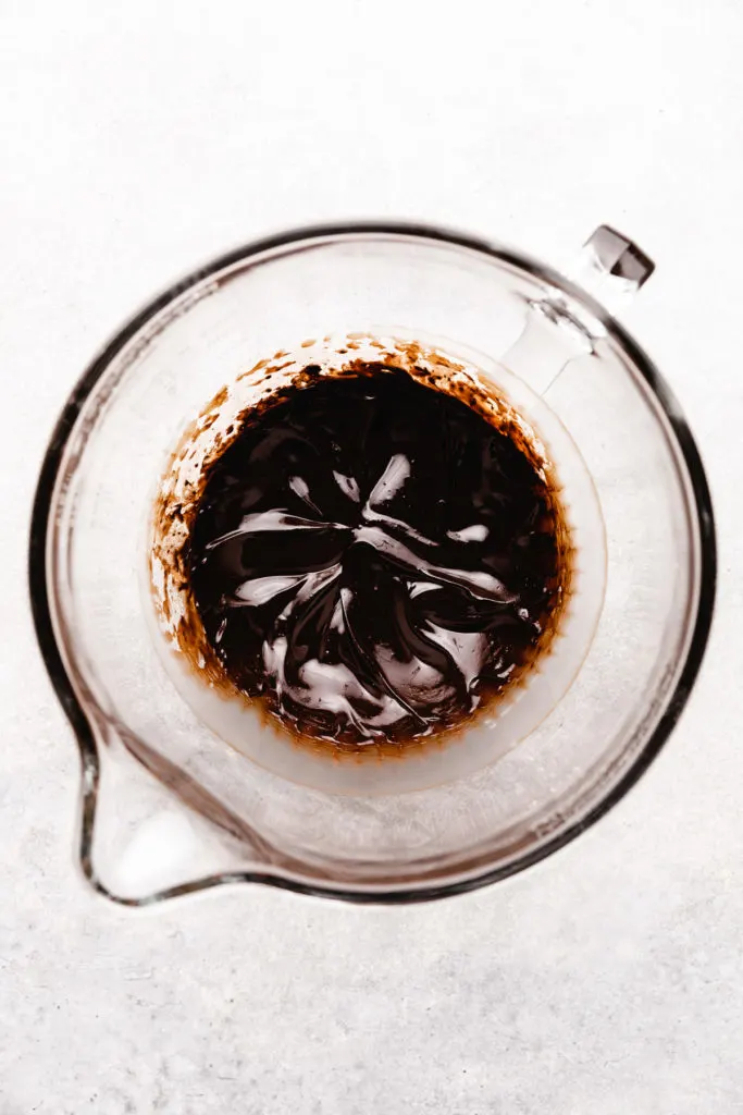 Cocoa powder and butter in a mixing bowl.