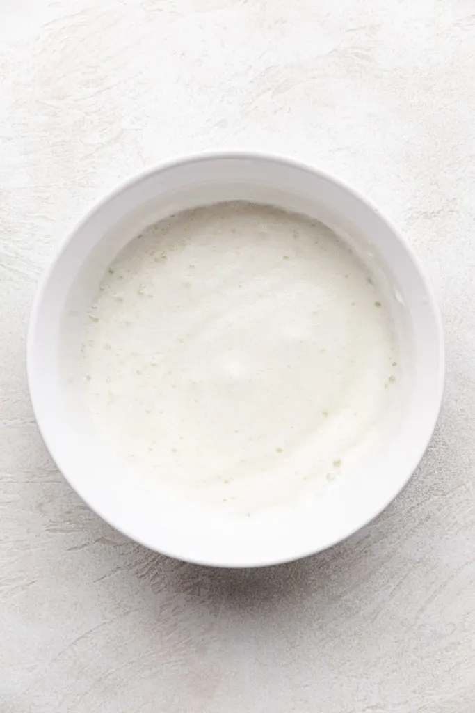 Frothy egg whites in a bowl.