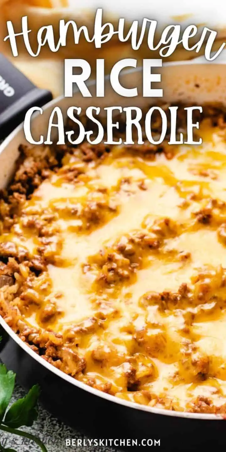 Close up view of cheesy hamburger rice casserole in a pan.