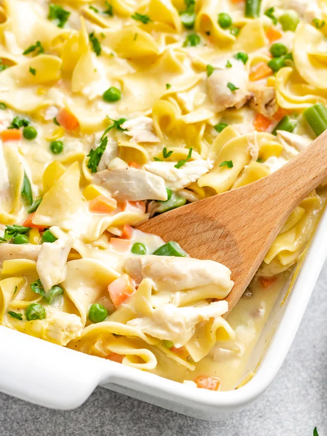 Creamy chicken noodle casserole in a white baking dish.