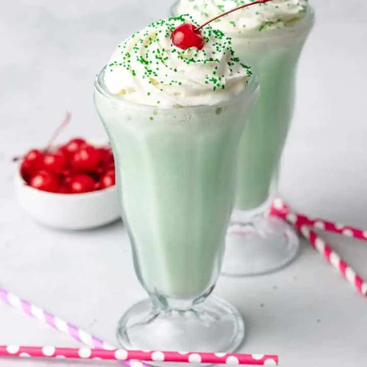 Close up view of two glasses filled with a copycat shamrock shake.