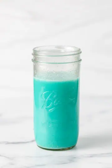 Blue hawaiian drink in a mason jar.