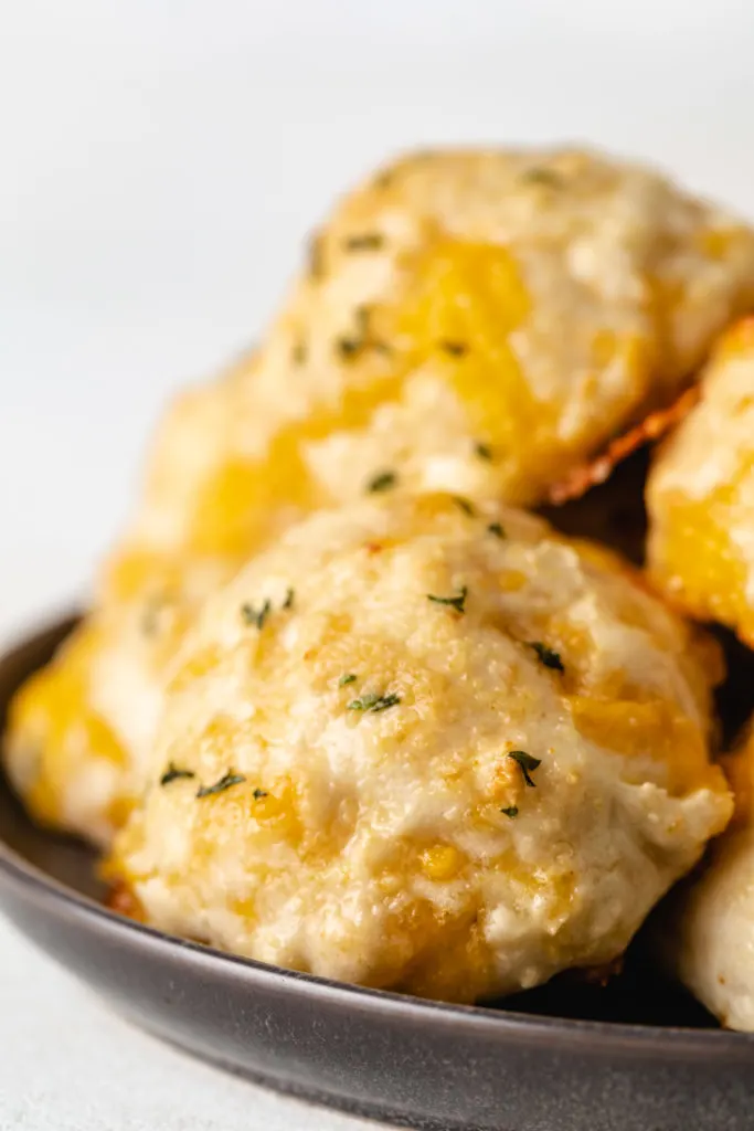 Garlic cheddar biscuits on a plate.