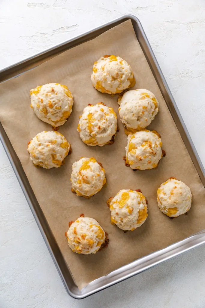 Baked biscuits on a baking sheet.