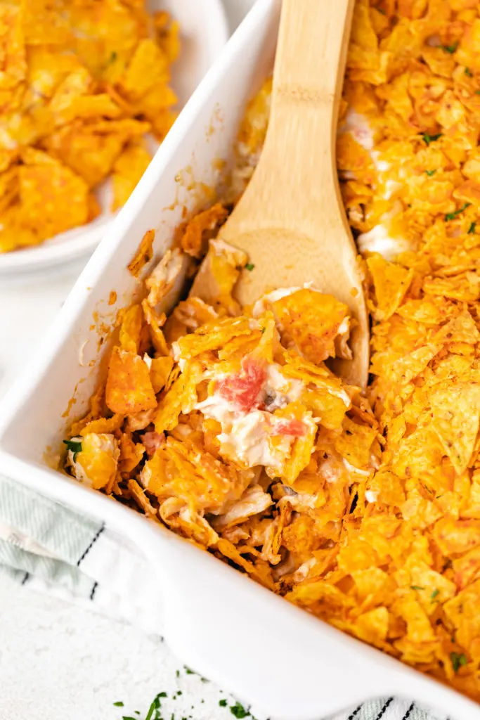 Spoon scooping casserole from a dish.