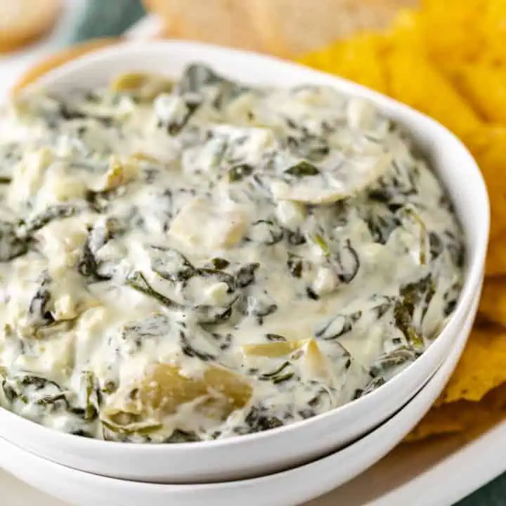 White bowl filled with spinach dip.