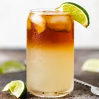 Side view of a lime wedge on a ginger beer drink.