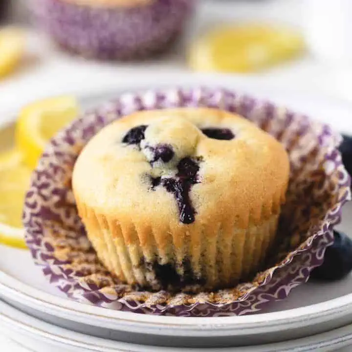 Close up view of a gluten free muffin on a paper liner.