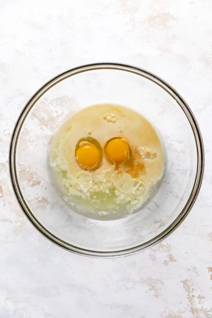 Eggs, milk and oil in a bowl.