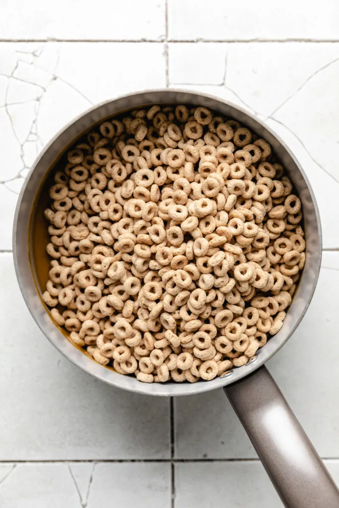 Cheerios poured over melted peanut butter and honey.