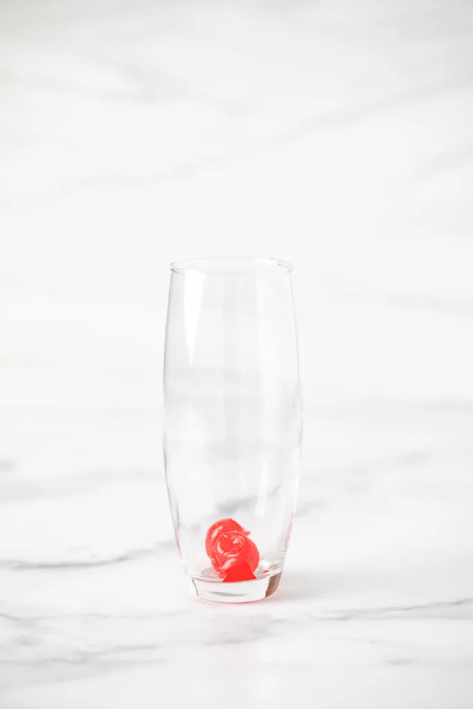 Maraschino cherries in a glass.