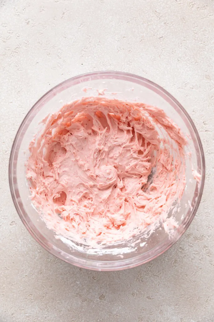 Bowl of strawberry frosting.