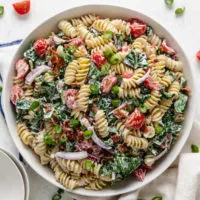 Top down view of a mixing bowl filled with blt pasta salad.