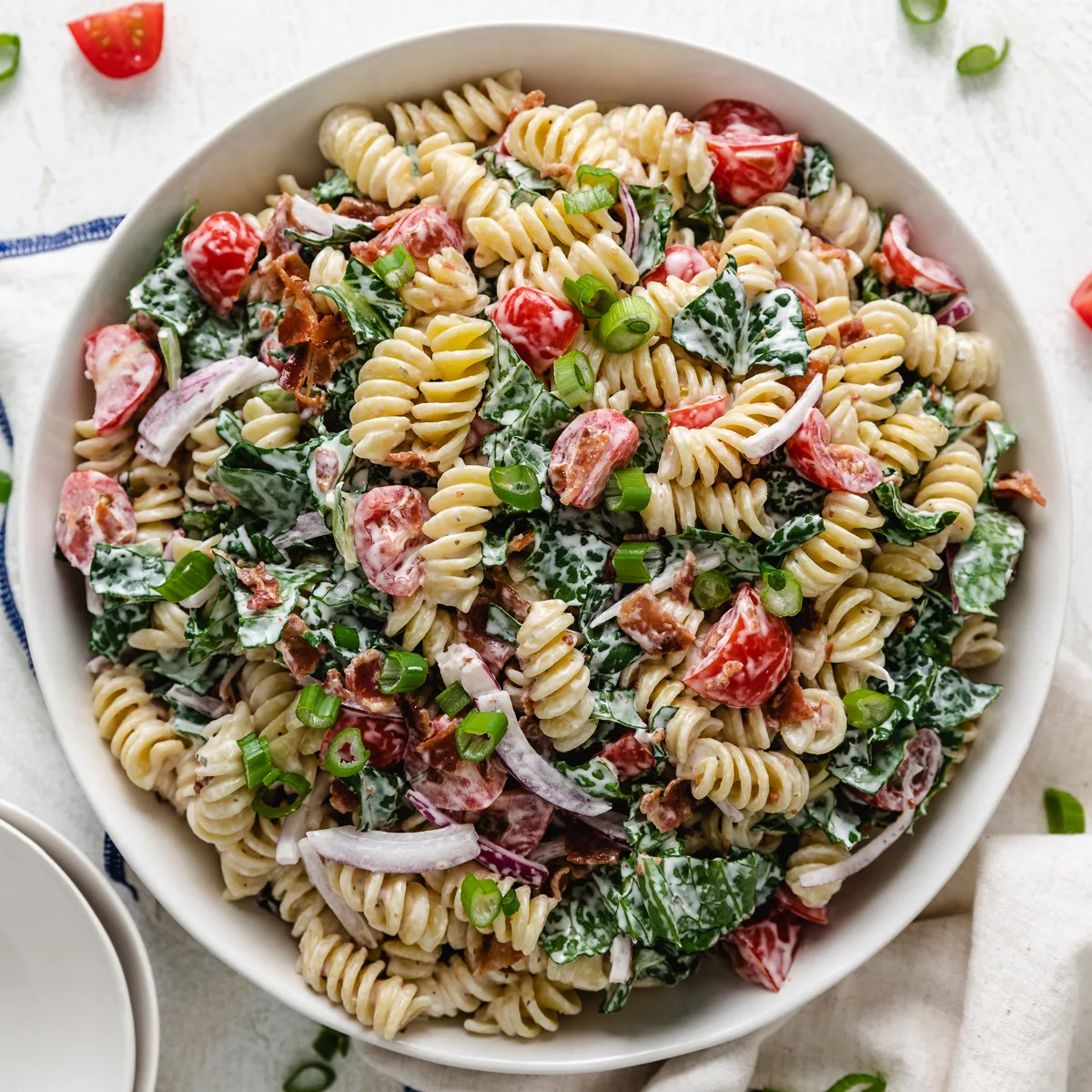 Top down view of a mixing bowl filled with blt pasta salad.