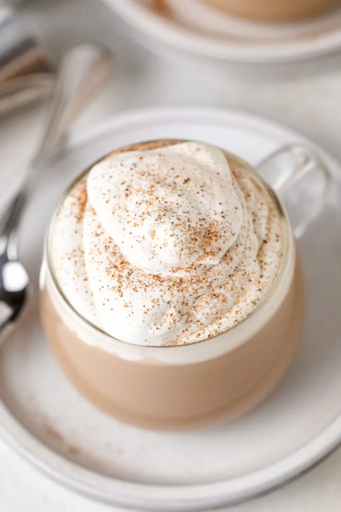 Top down view of whipped cream sprinkled with cinnamon.