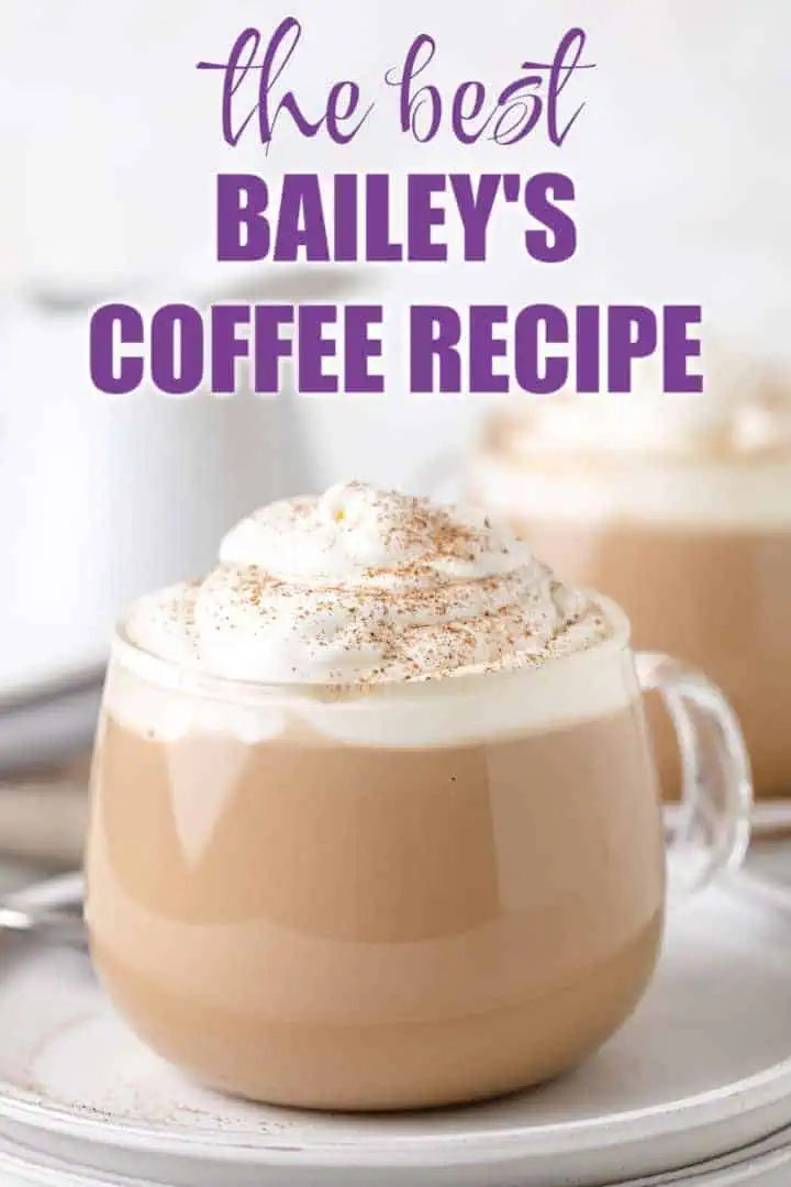 Glass coffee mug filled with bailey's, milk and coffee.