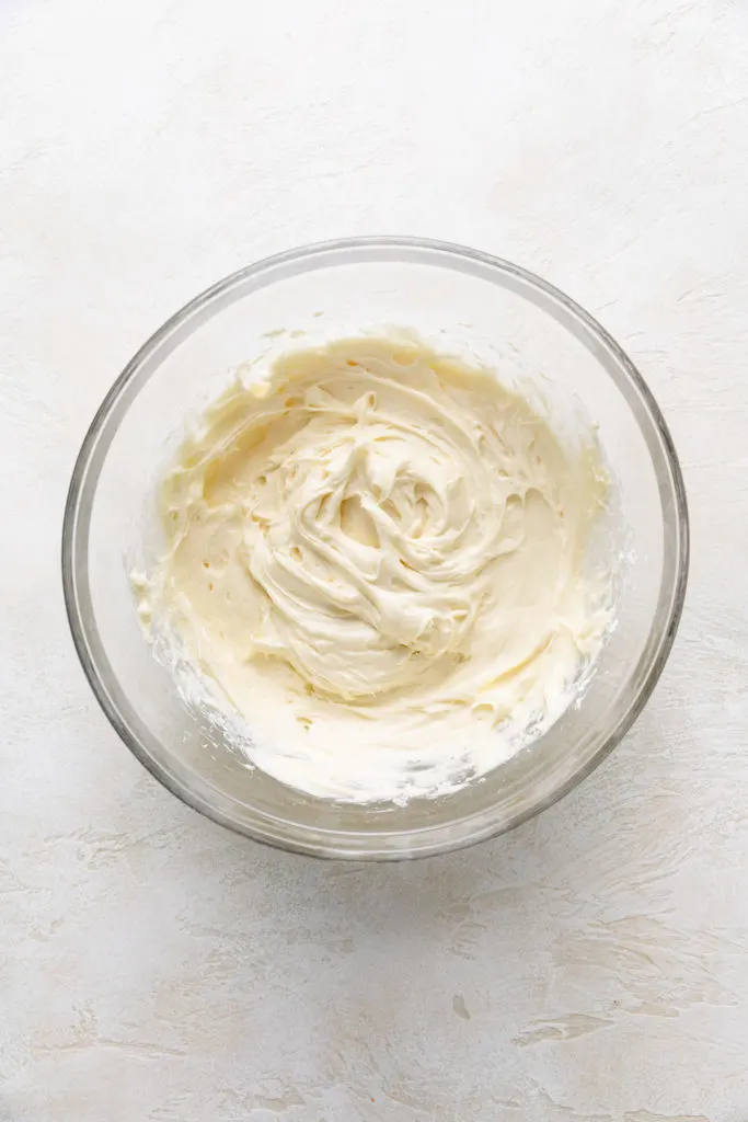 Cream cheese frosting in a bowl.