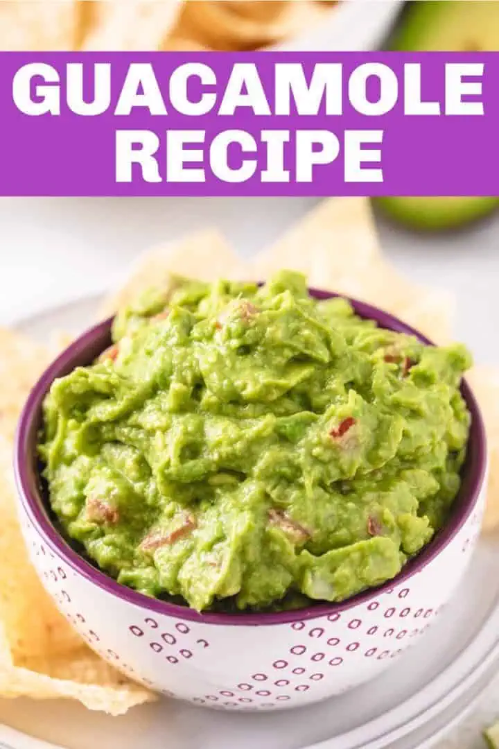 Close up view of avocado dip in a purple speckled bowl.