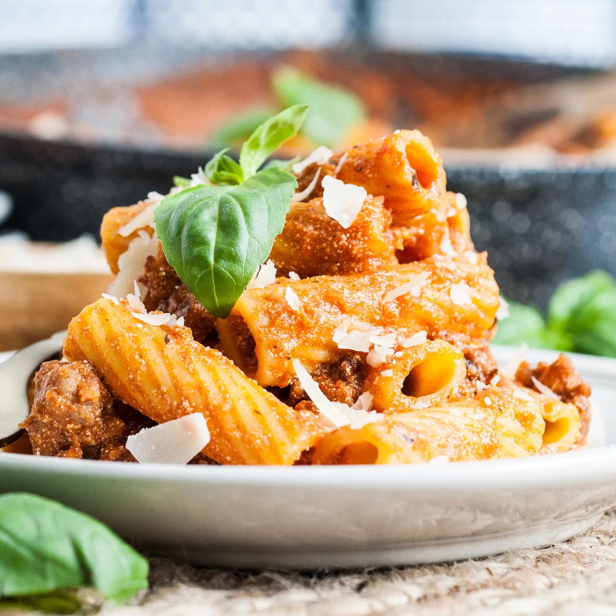 Close up view of italian sausage pasta on a plate.